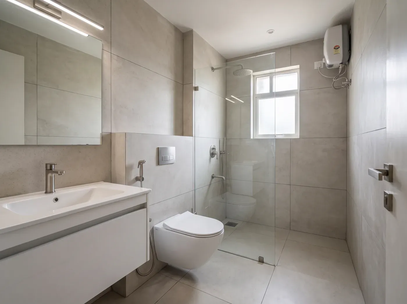 Clean Contemporary bathroom — a design visualisation showing light neutral tiles, simple lines, compact floating storage and restrained metal finishes to make smaller bathrooms feel ordered.