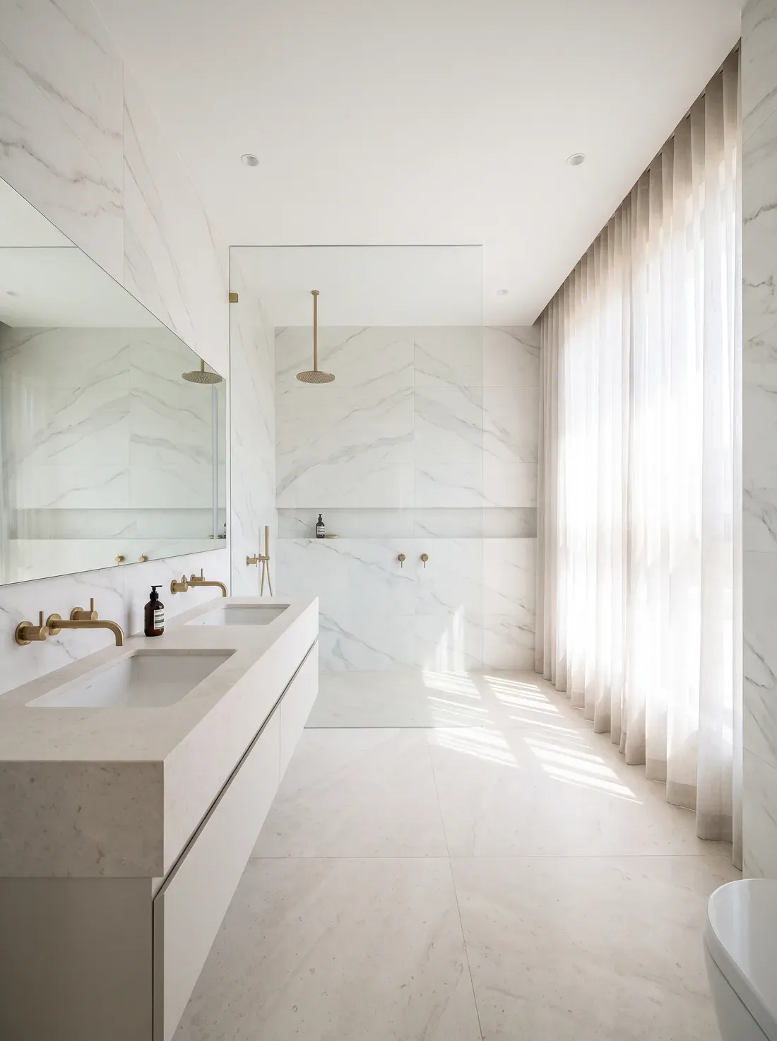A spacious villa master bathroom in white marble-look tile with a long double vanity, brass tapware and a walk-in shower — a design visualisation.